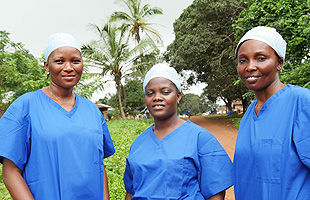 Ebola in Sierra Leone: Members of the GOAL reproductive health team on a daily visit to the expectant mothers in the quarantined village.