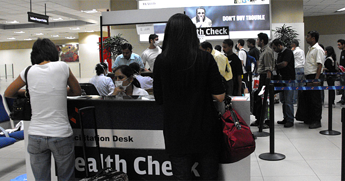 Travelers wearing masks in airport