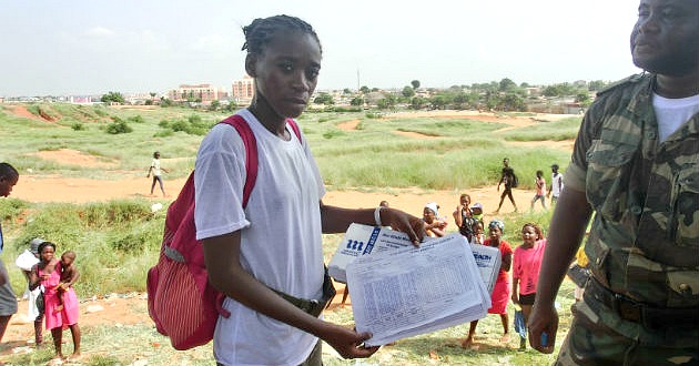 A woman holding registrations forms that keep track of the people who have been vaccinated in a yellow fever campaign.