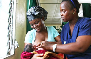 A midwife guides a mother who is breastfeeding her baby, Liberia.