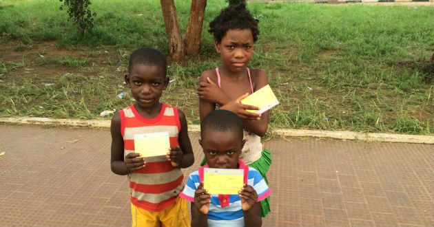 3 children holding yellow fever certificates